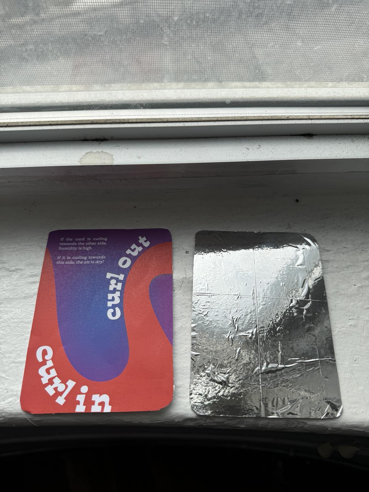 Card and mylar on windowsill